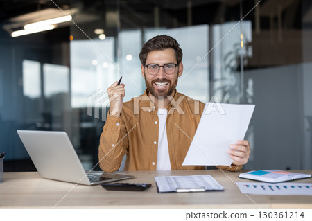 Office setting showcasing a confident employee reviewing documents with a smile Office setting showcasing a confident employee reviewing documents with a smile 130361214