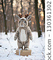 A rabbit standing in a snowy forest 130361302