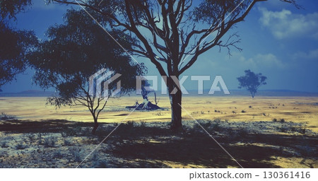 Dry, expansive landscape in the Australian Outback features scattered trees under a clear blue sky. The ground is parched, highlighting the regions arid conditions and natural beauty. Dry, expansive landscape in the Australian Outback features scattered trees under a clear blue sky. The ground is parched, highlighting the regions arid conditions and natural beauty. 130361416