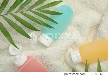 Travel bottles with body care cosmetics on soft background Travel bottles with body care cosmetics on soft background 130361615