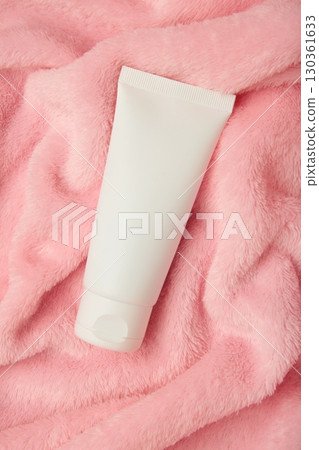 Winter skin care. Hand cream and soft pink background. Vertical photo 130361633