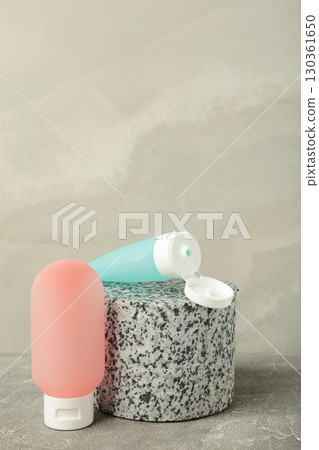 Cosmetic bottle on grey concrete background. Space for text Cosmetic bottle on grey concrete background. Space for text 130361650