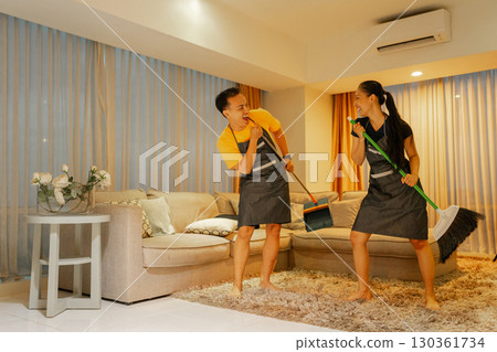 Dancing While Cleaning Couples Have Fun Enjoying Housework Together in Harmony 130361734