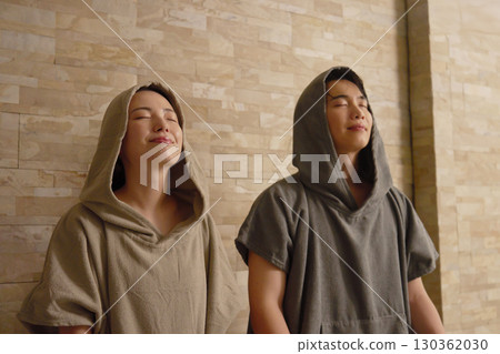 Young couple using the sauna Young couple using the sauna 130362030