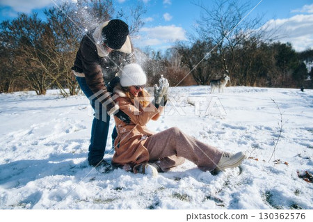 Fun winter day with friends playing in the snow outdoors 130362576