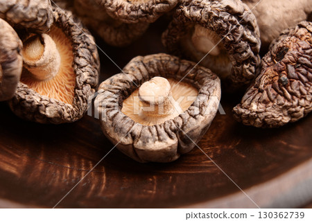 Nutritious dried shiitake mushrooms. Edible Asian ingredient. Macro shot Nutritious dried shiitake mushrooms. Edible Asian ingredient. Macro shot 130362739