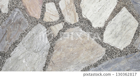 Decorative stone pavement with irregularly shaped natural rocks set in concrete. Decorative stone pavement with irregularly shaped natural rocks set in concrete. 130362817