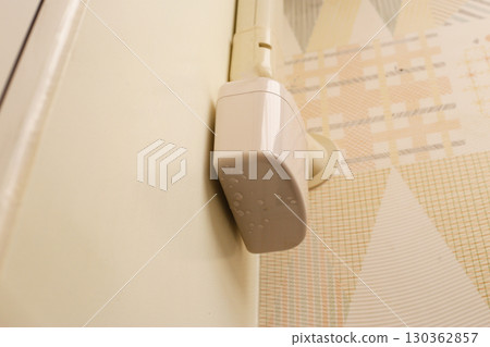 Wall-mounted drain pump for air conditioner with water droplets underneath, indicating malfunction or leakage. 130362857