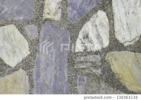 Decorative stone pavement with irregularly shaped natural rocks set in concrete. 130363138