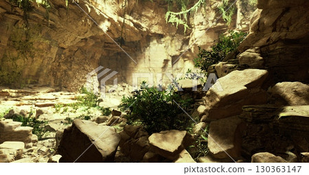 Sunlight filters through a natural opening in a stunning cave, illuminating lush greenery and weathered rocks. The atmosphere exudes tranquility and wonder, inviting exploration and adventure. 130363147