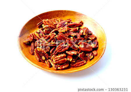 Delicious salted pecan nuts scattered. Delicious salted pecan nuts scattered. 130363231
