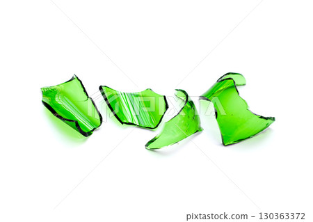 Sharp green glass shards scattered on a white background. Sharp green glass shards scattered on a white background. 130363372