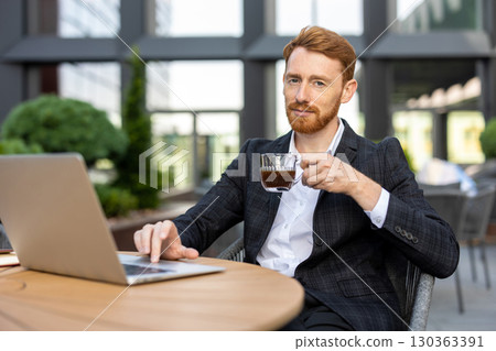 Young adult professional drinking coffee while working \ 130363391