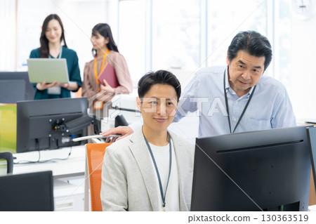 Male and female engineers working in the office 130363519