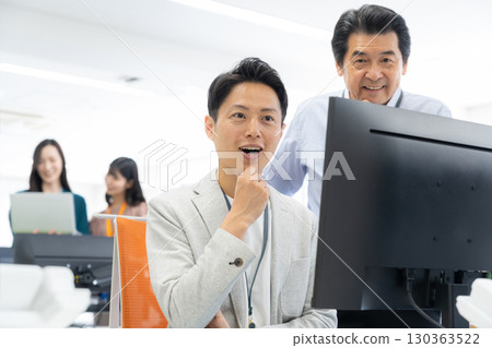Male and female engineers working in the office 130363522