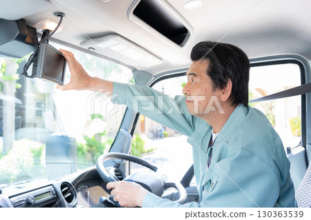 Middle male driver driving a truck 130363539