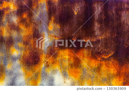 brown rusted sheet metal surface with white spray paint remnants 130363909