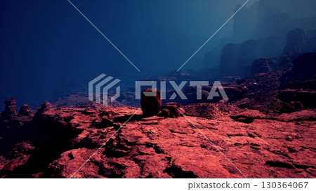 A serene dusk settling over the rugged red cliffs of a canyon under a deep blue sky. A serene dusk settling over the rugged red cliffs of a canyon under a deep blue sky. 130364067