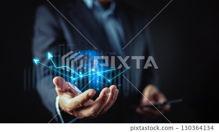 A person holding global and graph stock to plan in e-business, the use of online digital network technology in business, buying and selling commerce online digital marketplace A person holding global and graph stock to plan in e-business, the use of online digital network technology in business, buying and selling commerce online digital marketplace 130364134