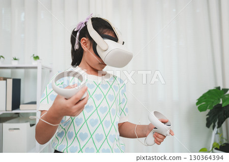 Child fully engaged in virtual reality world, playing interactive simulation game with futuristic headset. 130364394