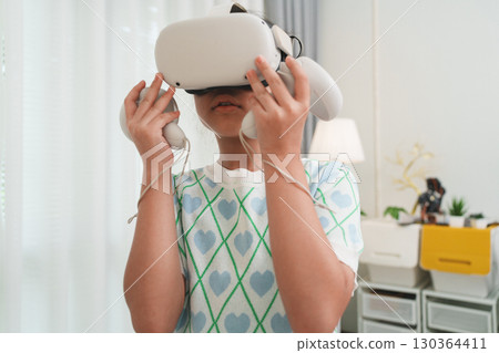 Young Girl Exploring VR for STEM Education and Gaming Fun Young Girl Exploring VR for STEM Education and Gaming Fun 130364411