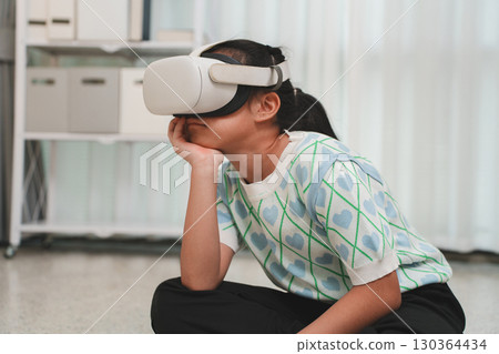 Young learner focused on a creative project in virtual reality. 130364434