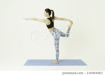 Young woman doing dancer pose on white background, yoga 130364462