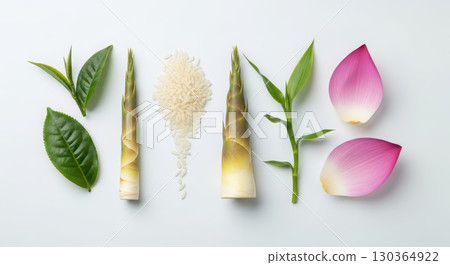 Fresh bamboo shoots, rice grains, green tea leaves, and pink lotus petals arranged artistically on a white background, showcasing natural ingredients and vibrant colors in a culinary context 130364922