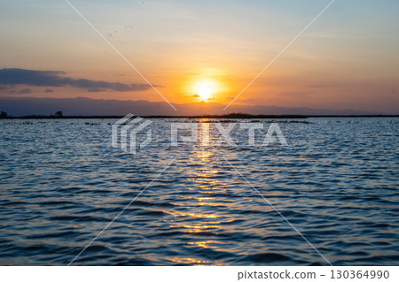 Sunset over Lake Tempe in Sulawesi, Indonesia's peaceful waters Sunset over Lake Tempe in Sulawesi, Indonesia's peaceful waters 130364990