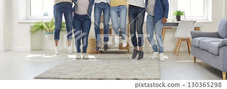 Banner with a cropped shot of a group of happy young friends jumping all together 130365298