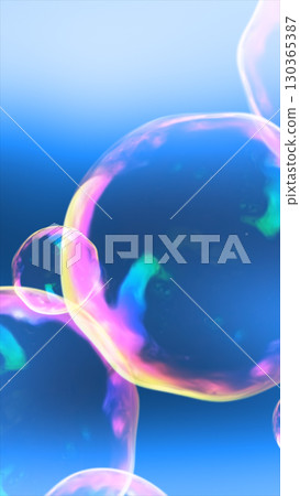 Vibrant iridescent soap bubbles floating against a bright blue background 130365387