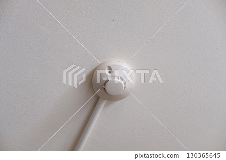 Modern fire sprinkler system mounted on white ceiling ensuring safety in commercial building Modern fire sprinkler system mounted on white ceiling ensuring safety in commercial building 130365645