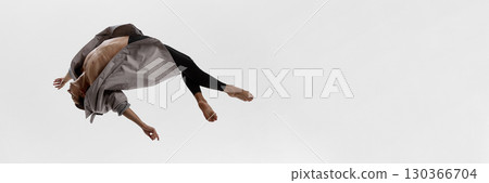 Male dancer twisting midair in coat with curved torso and emotional abstraction. Banner Male dancer twisting midair in coat with curved torso and emotional abstraction. Banner 130366704