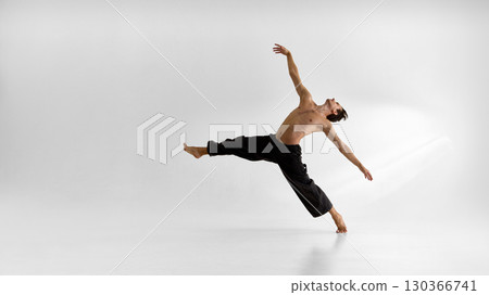 Male dancer leaping with open torso expressive face and dramatic emotional release Male dancer leaping with open torso expressive face and dramatic emotional release 130366741