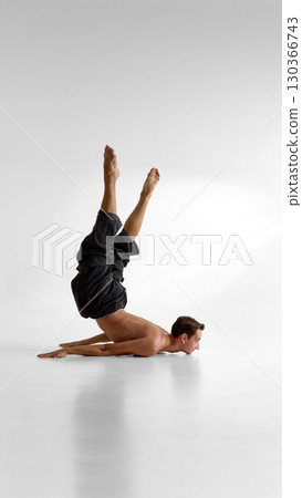 Bare male torso balancing inverted on floor with intense emotion and body control Bare male torso balancing inverted on floor with intense emotion and body control 130366743