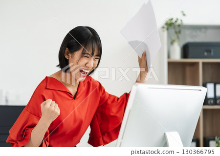 Successful business woman, excited young woman Keeping up arms and showing positive emotions, happy working in modern office on computer. Successful business woman, excited young woman Keeping up arms and showing positive emotions, happy working in modern office on computer. 130366795