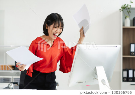 Successful business woman, excited young woman Keeping up arms and showing positive emotions, happy working in modern office on computer. Successful business woman, excited young woman Keeping up arms and showing positive emotions, happy working in modern office on computer. 130366796