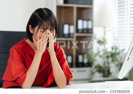 stressed businesswoman working in the office. Businessman thinking too much work concept in the office. 130366809