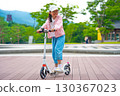 Asian girl is going to ride a scooter. Copy space 130367023