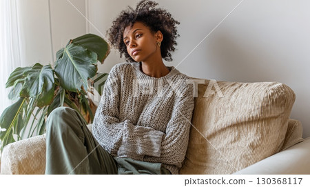Pensive Woman Relaxing on Cozy Sofa at Home Pensive Woman Relaxing on Cozy Sofa at Home 130368117