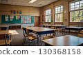 A cozy, empty elementary school classroom with wooden desks, large windows, and children's drawings on the walls, bathed in natural daylight. The concept of the beginning of the school year. 130368158