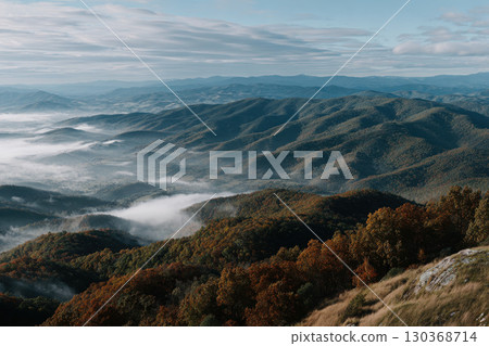 Autumn landscape showing misty mountains in the early morning light 130368714