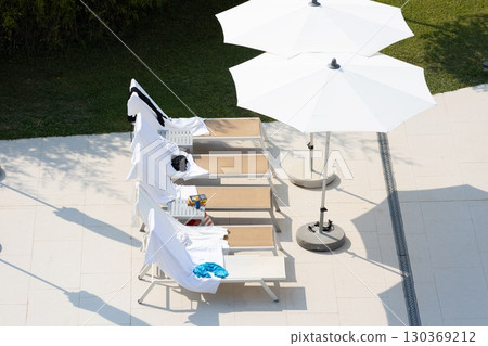 Poolside umbrellas at a resort hotel 130369212