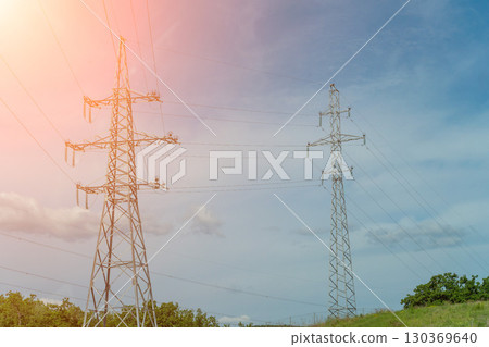 High voltage towers with sky background. Power line support with wires for electricity transmission. High voltage grid tower with wire cable at distribution station. Energy industry, energy saving High voltage towers with sky background. Power line support with wires for electricity transmission. High voltage grid tower with wire cable at distribution station. Energy industry, energy saving 130369640