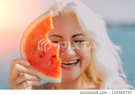 Watermelon Woman Summer: Beach Fun, joyful woman playfully holds a watermelon slice, summer outdoor portrait. Watermelon Woman Summer: Beach Fun, joyful woman playfully holds a watermelon slice, summer outdoor portrait. 130369743