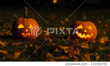 Halloween pumpkins on the grass in the park at night spooky holiday decoration 130369792