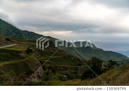 A mountain range with a cloudy sky A mountain range with a cloudy sky 130369799