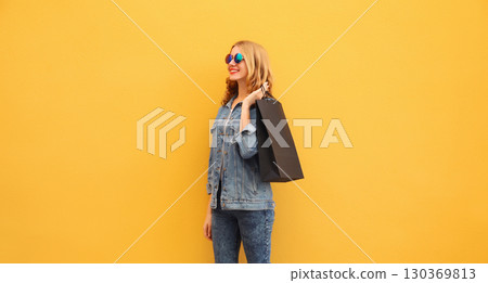 Shopping day, stylish happy smiling young woman with black shopping bags 130369813