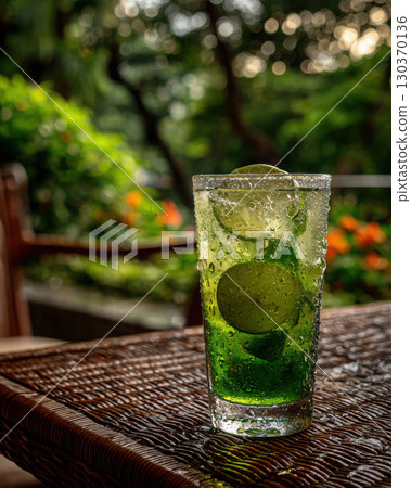 Chilled lime green tea served in a garden setting 130370136