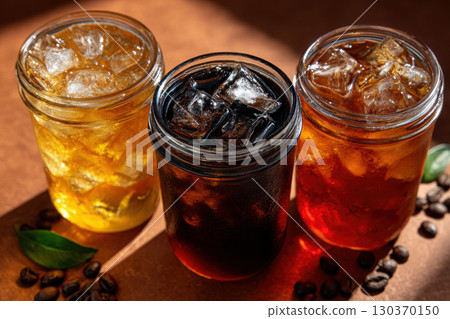 Layered iced teas create a colorful refreshment display Layered iced teas create a colorful refreshment display 130370150